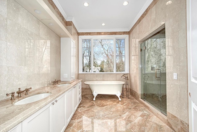 bathroom with ornamental molding, a sink, and tile walls