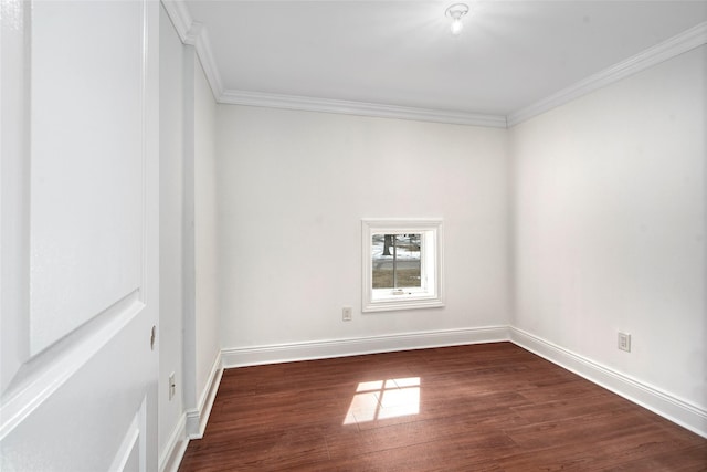 unfurnished room featuring ornamental molding, dark wood finished floors, and baseboards