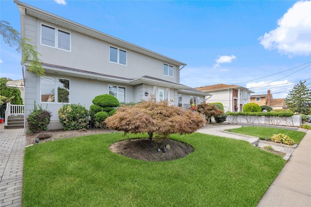 view of front of property with a garage and a front yard