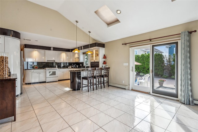 kitchen featuring light tile patterned flooring, decorative light fixtures, white cabinets, a kitchen breakfast bar, and white range with gas stovetop