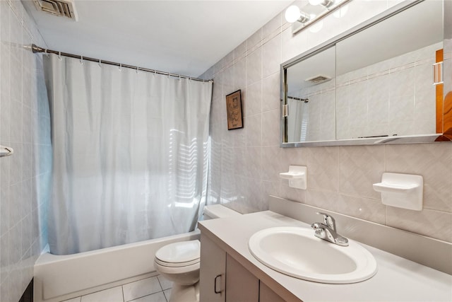 full bathroom featuring shower / tub combo with curtain, toilet, tile walls, vanity, and tile patterned flooring