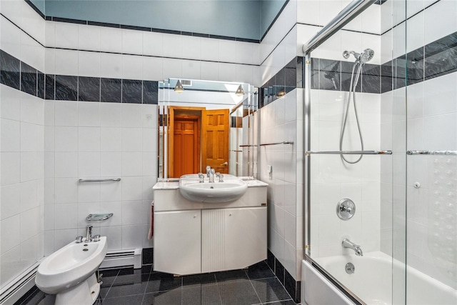 bathroom with a bidet, enclosed tub / shower combo, tile walls, vanity, and a baseboard radiator