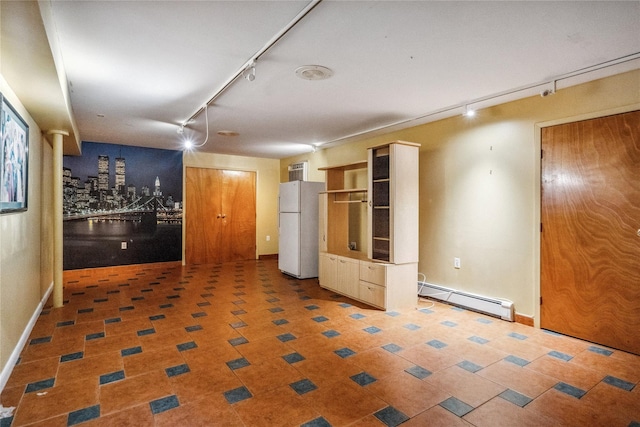 interior space featuring rail lighting and a baseboard heating unit