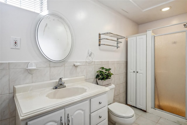 bathroom featuring tile walls, vanity, tile patterned floors, toilet, and walk in shower