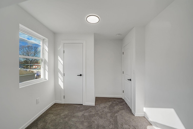 unfurnished bedroom featuring dark carpet