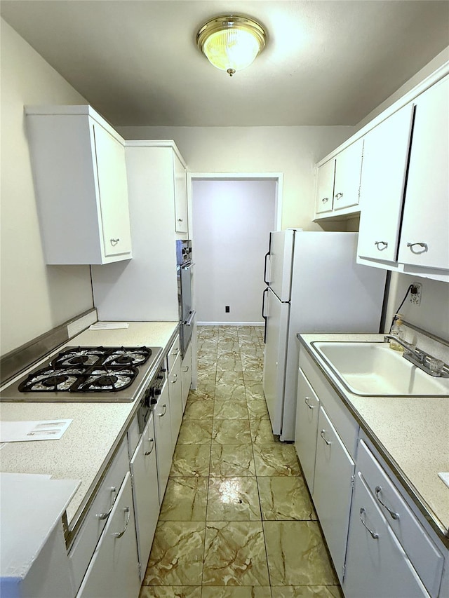 kitchen with white cabinetry, gas stovetop, and sink