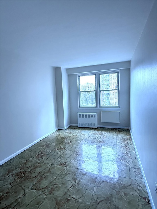 spare room featuring radiator heating unit