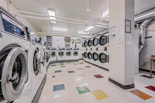 laundry area with stacked washer / dryer and washing machine and clothes dryer