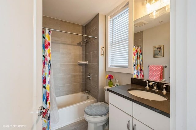 full bathroom with vanity, toilet, and shower / bath combo