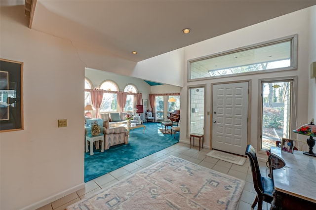 entryway with light carpet, light tile patterned floors, baseboards, lofted ceiling, and recessed lighting