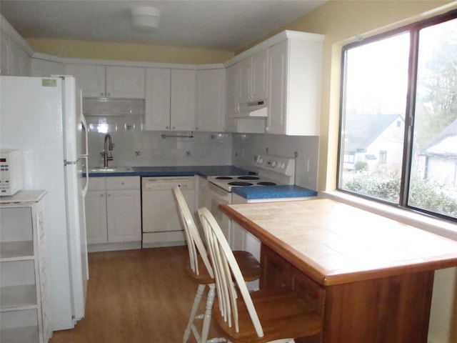 kitchen featuring sink, white appliances, white cabinetry, tasteful backsplash, and tile countertops