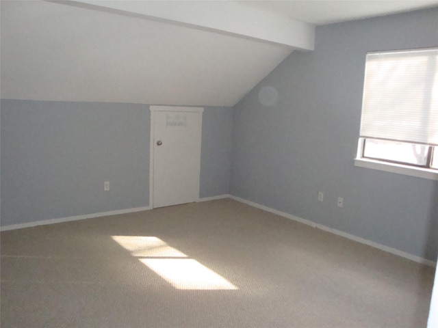 additional living space with carpet and vaulted ceiling with beams