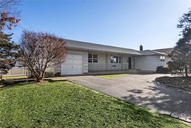 ranch-style home featuring a garage and a front yard