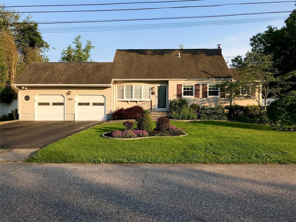 view of front of house featuring a garage and a front lawn