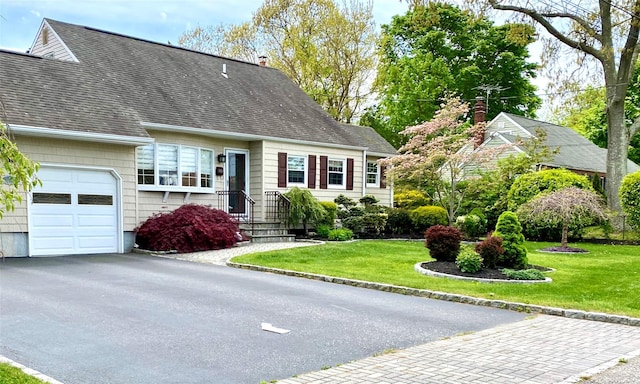 cape cod home featuring a garage and a front yard