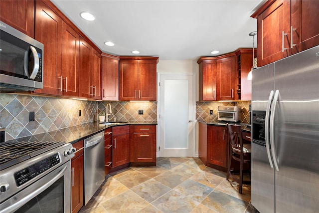 kitchen featuring appliances with stainless steel finishes, sink, dark stone counters, and backsplash