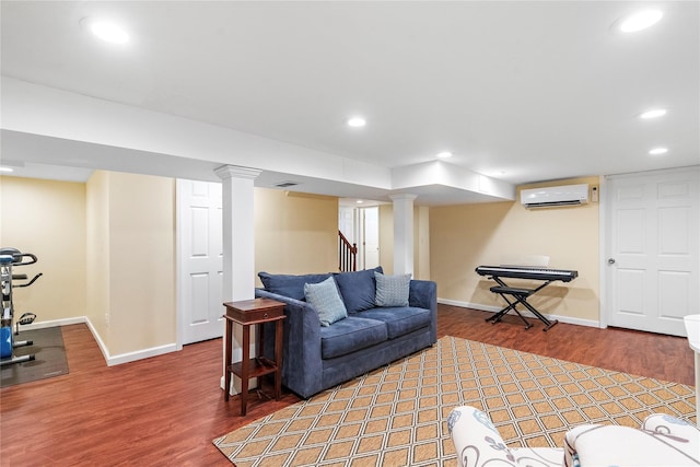 living room with dark wood-type flooring and a wall mounted air conditioner