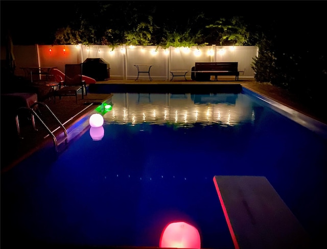 view of pool at night