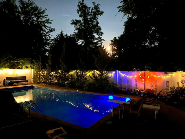 view of pool at dusk