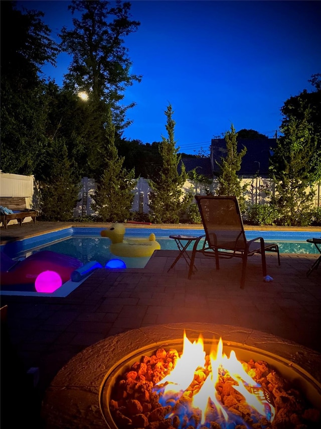 view of pool featuring a patio area and an outdoor fire pit