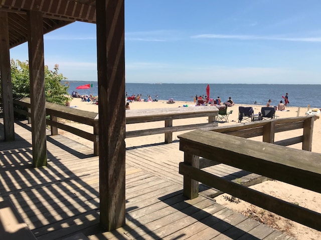 exterior space with a water view and a beach view