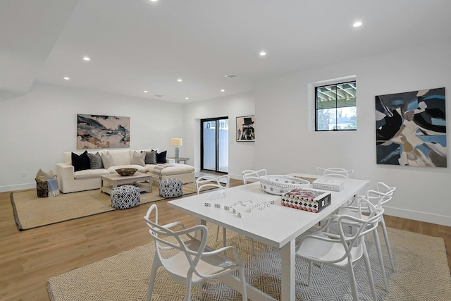 dining area with recessed lighting, baseboards, and light wood finished floors