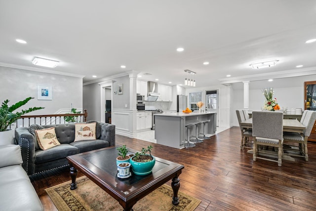 living room with crown molding, decorative columns, and dark hardwood / wood-style floors