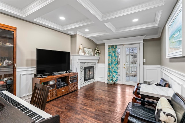 living room featuring french doors, a premium fireplace, beam ceiling, and hardwood / wood-style flooring