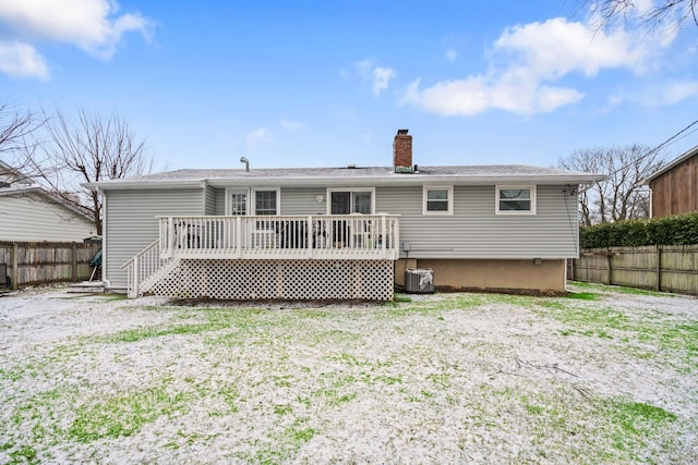 rear view of property featuring a wooden deck and central AC