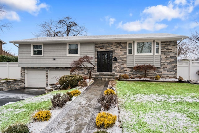 view of front of house with a garage and a front yard