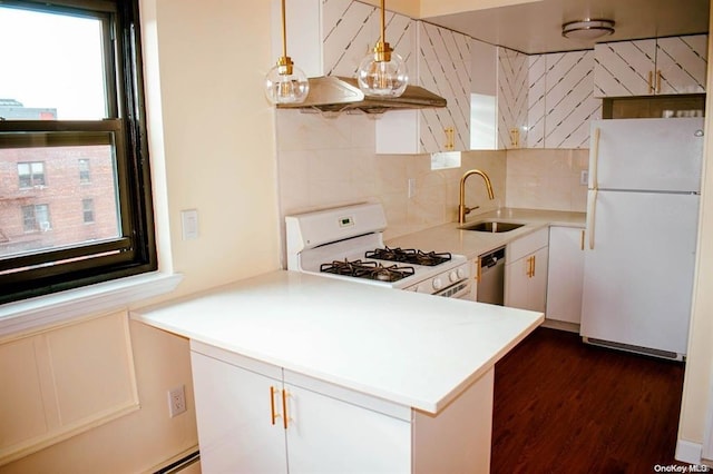 kitchen featuring sink, white appliances, white cabinets, decorative light fixtures, and kitchen peninsula