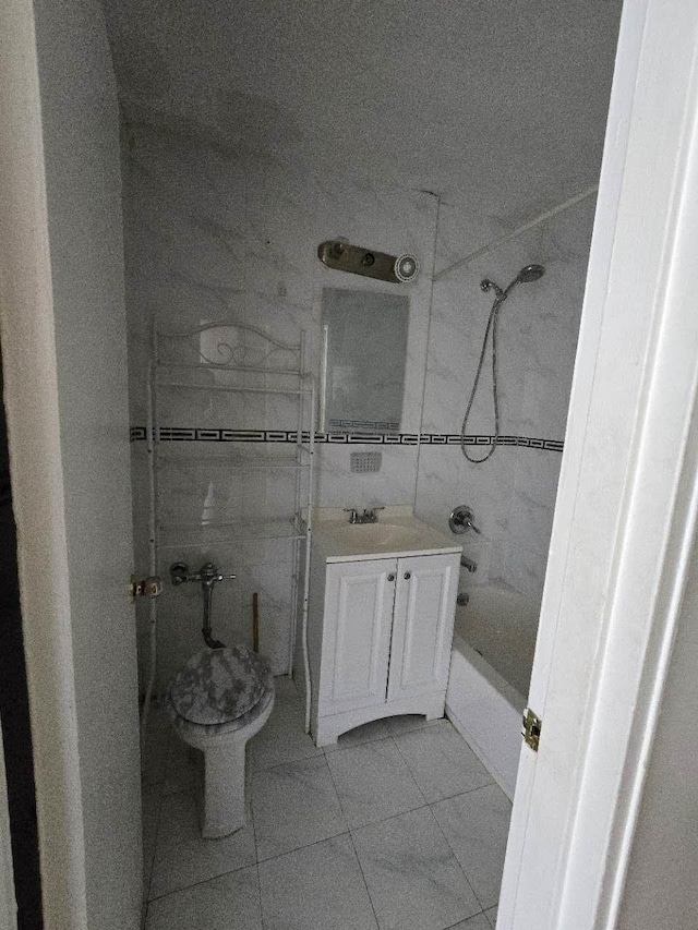 full bathroom featuring tile patterned floors, vanity, toilet, and tiled shower / bath combo