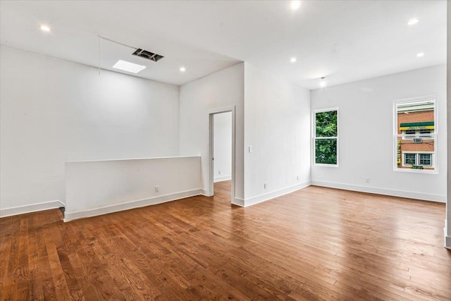 spare room with wood-type flooring