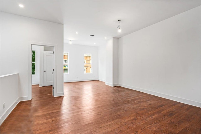 spare room with dark hardwood / wood-style flooring