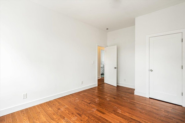 unfurnished bedroom featuring dark wood-type flooring