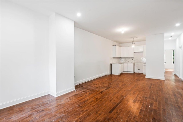 unfurnished living room with dark hardwood / wood-style floors