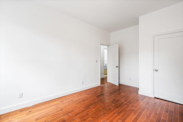 unfurnished bedroom featuring dark hardwood / wood-style flooring