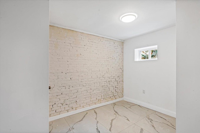 unfurnished room with brick wall