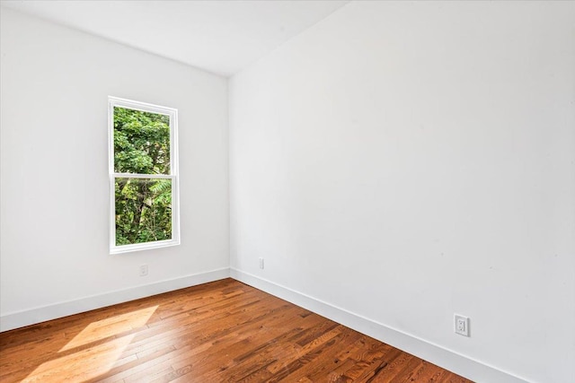 spare room with hardwood / wood-style floors