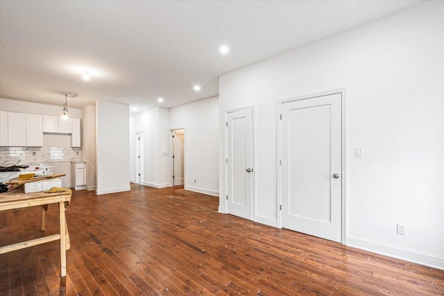 interior space with dark hardwood / wood-style flooring and white cabinets