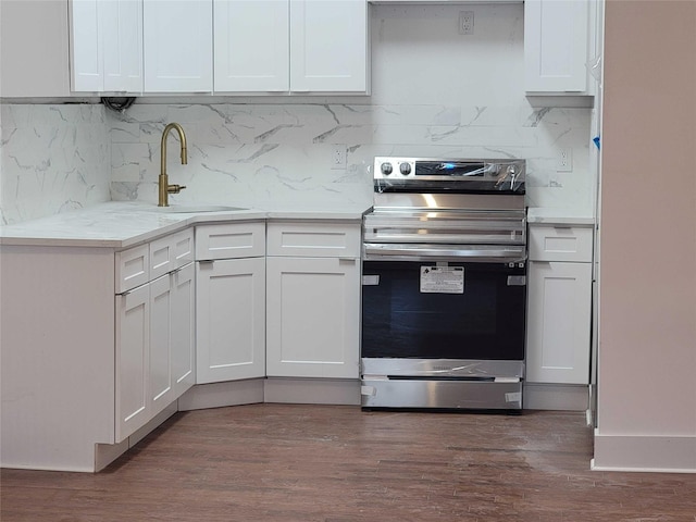 kitchen featuring sink, white cabinetry, dark hardwood / wood-style floors, light stone counters, and stainless steel electric stove