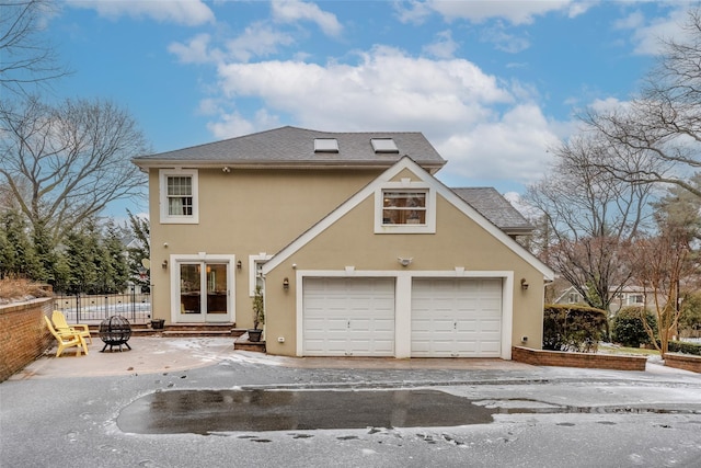 back of property with a garage