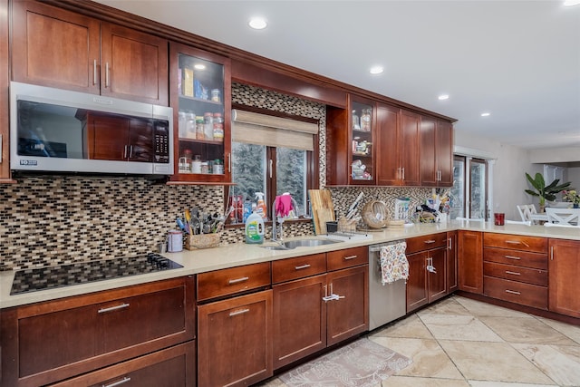 kitchen with backsplash, stainless steel appliances, and sink