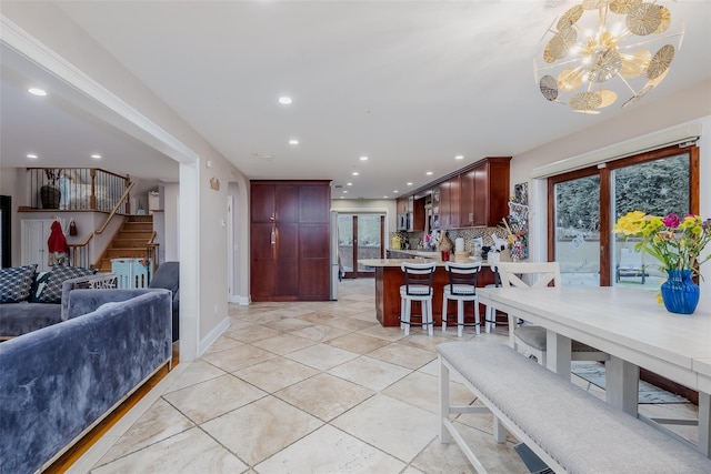 tiled dining room featuring a chandelier