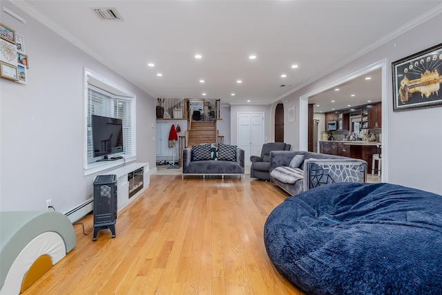 living room featuring crown molding, a baseboard radiator, and light hardwood / wood-style flooring