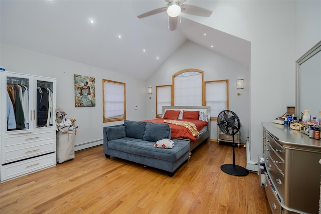 bedroom with a baseboard heating unit, light hardwood / wood-style floors, high vaulted ceiling, and ceiling fan