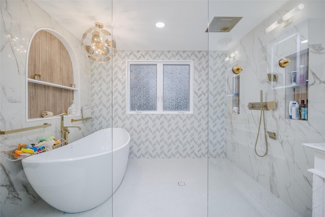 bathroom featuring shower with separate bathtub and tile walls