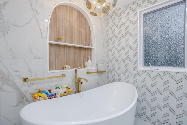 bathroom featuring tile walls and a tub to relax in