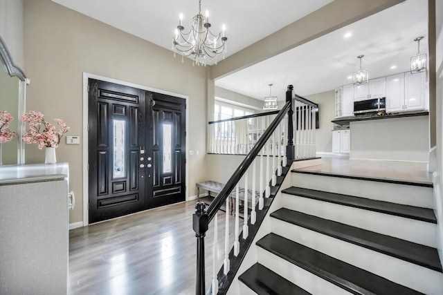 foyer featuring light hardwood / wood-style floors and a chandelier