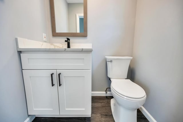 bathroom featuring vanity, toilet, and wood-type flooring